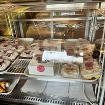 Bakery case of boxed pies, cookie trays and packaged sweets