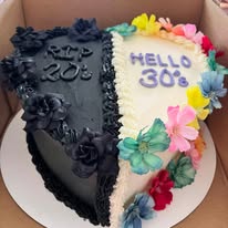 Half black, half white cake reading RIP 20s and Hello 30s with sugar flowers