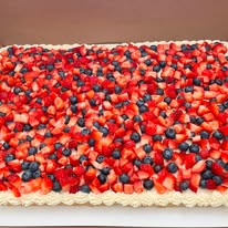 Large fruit tart sheet covered in strawberries and blueberries
